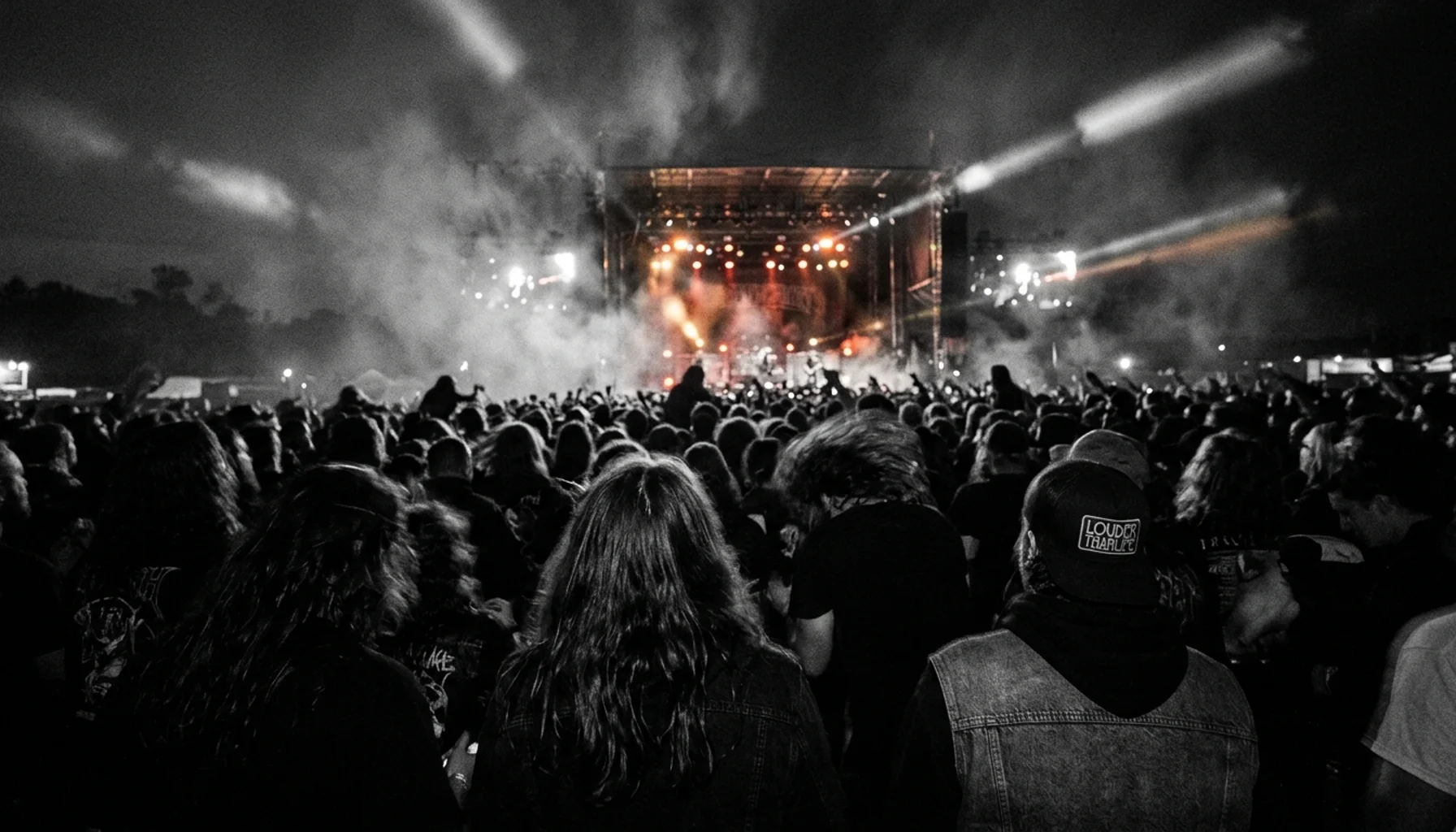 Crowd silhouettes under stage haze at Louder Than Life Festival Louisville concert