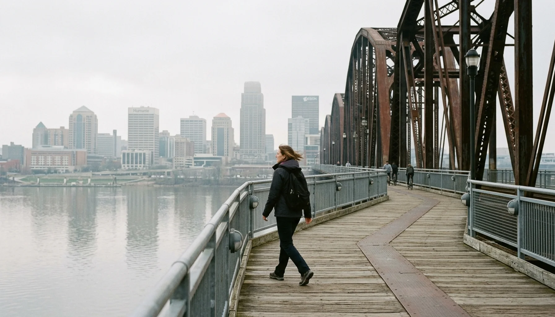 Walker crossing Big Four Bridge, one of the most photogenic places Louisville offers for skyline views