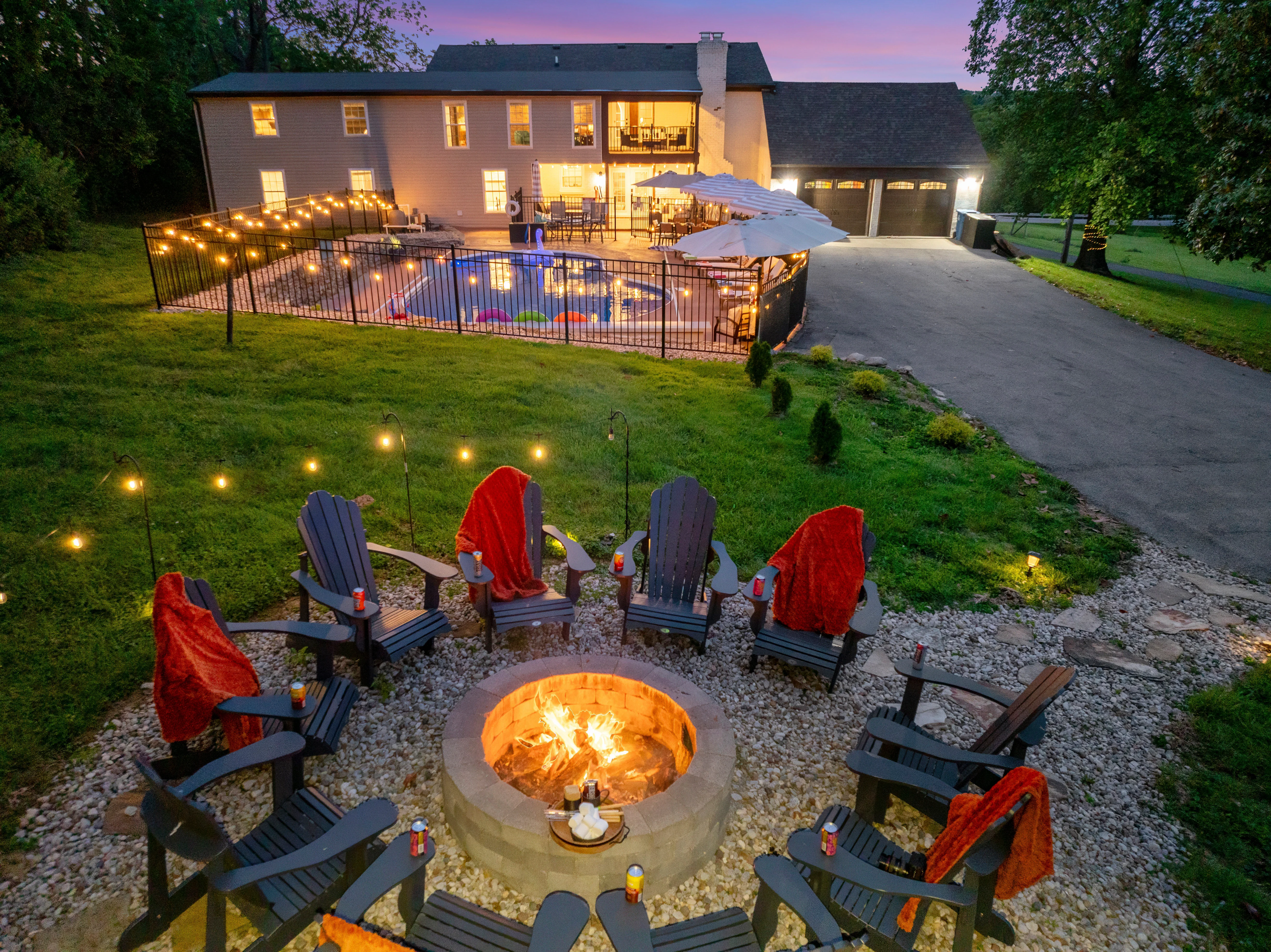 Backyard fire pit and pool area at twilight near the best hikes near Louisville basecamp in La Grange