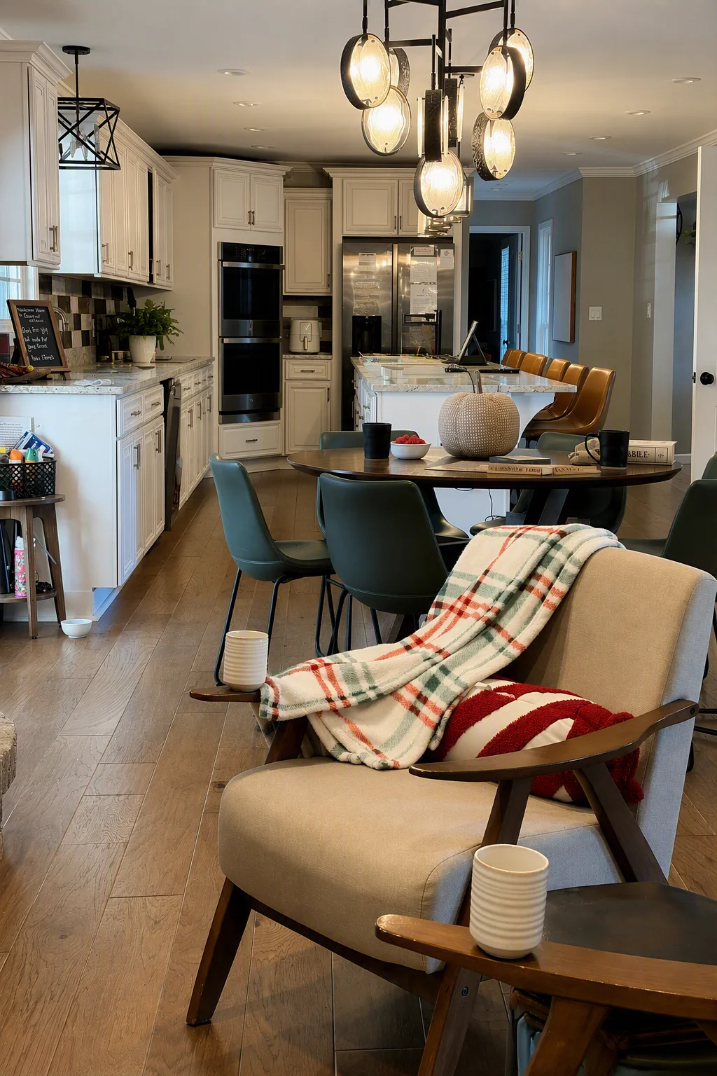 Open-concept kitchen with cream cabinets, marble island, and stainless steel appliances at Glencairn Knoll, Louisville KY