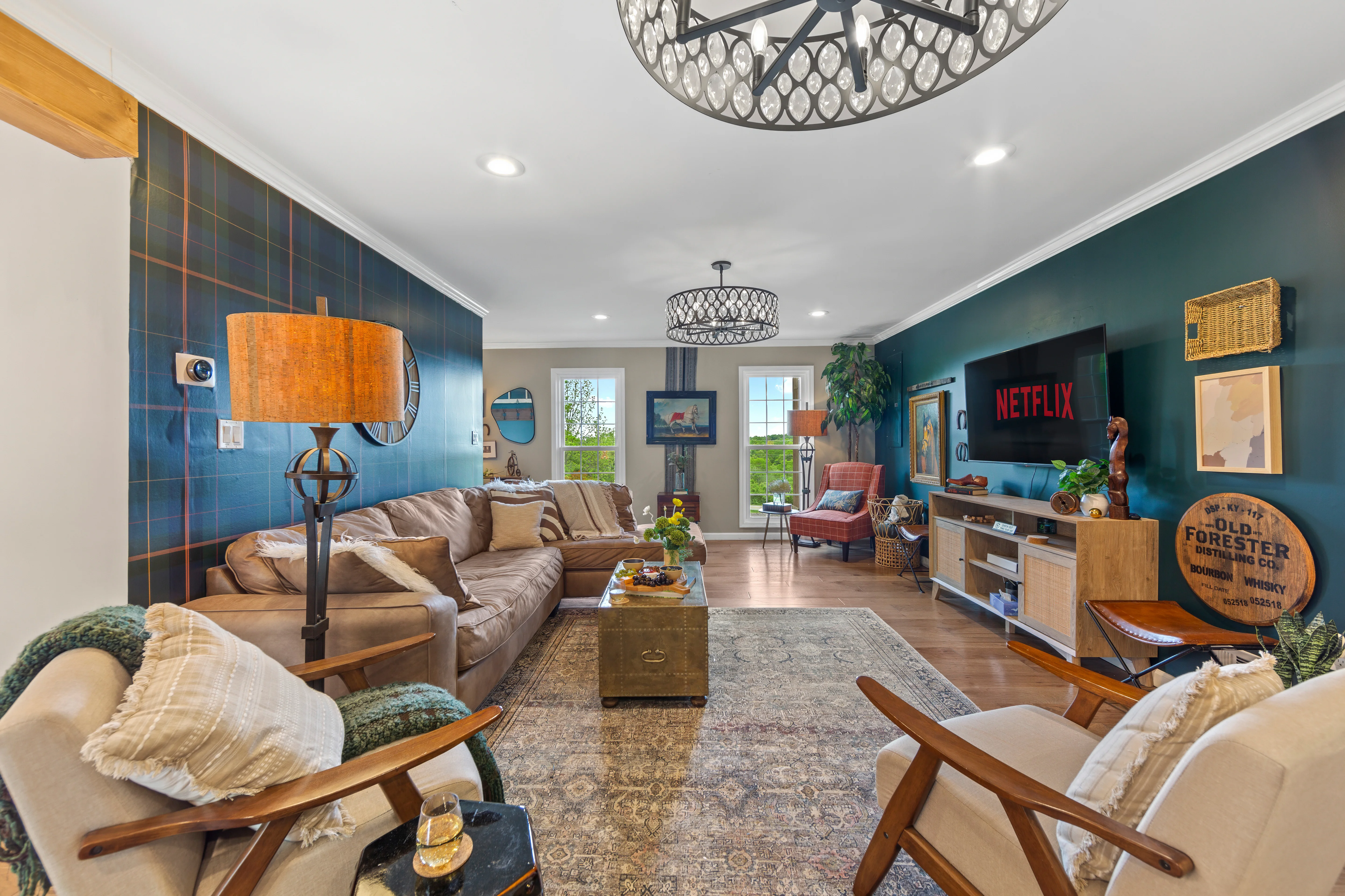 Mid-century modern living room with teal accent walls and comfortable seating at Glencairn Knoll Louisville