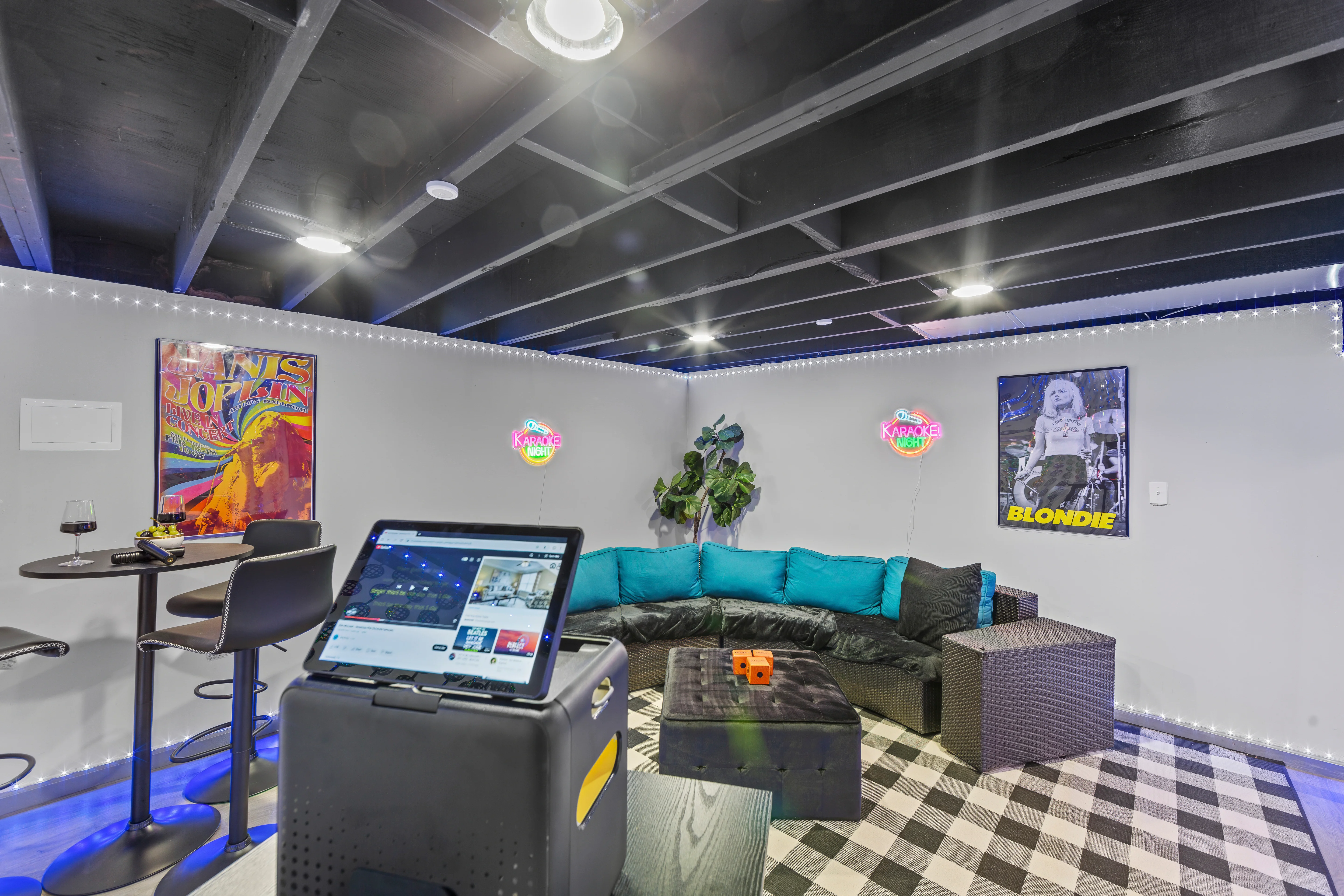 Modern basement entertainment room with turquoise sectional and karaoke setup perfect for bachelorette party Louisville