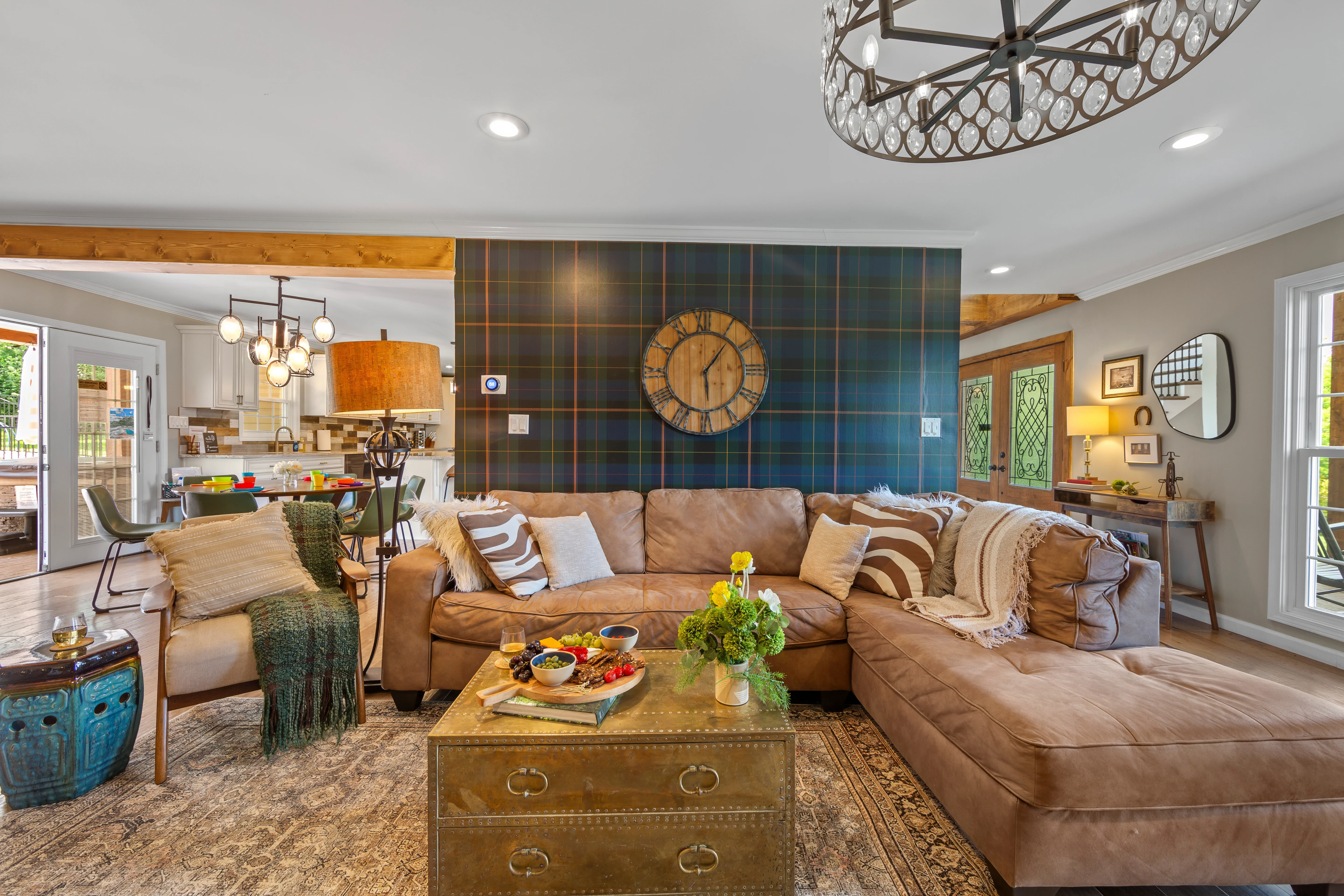 Spacious living room with caramel leather sectional for large group getaway in Louisville