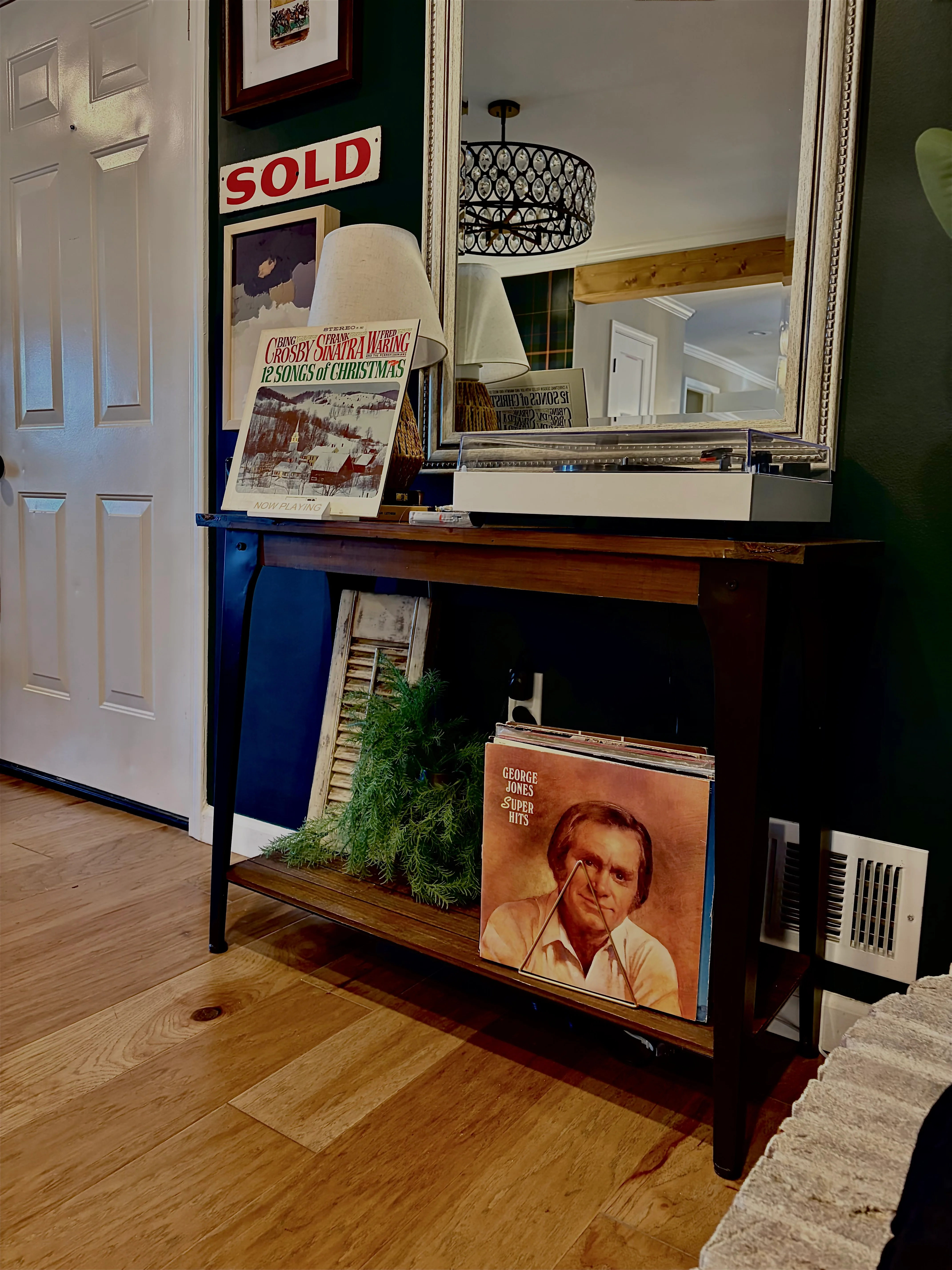 Rustic living room with vintage vinyl records and console table at Glencairn Knoll La Grange