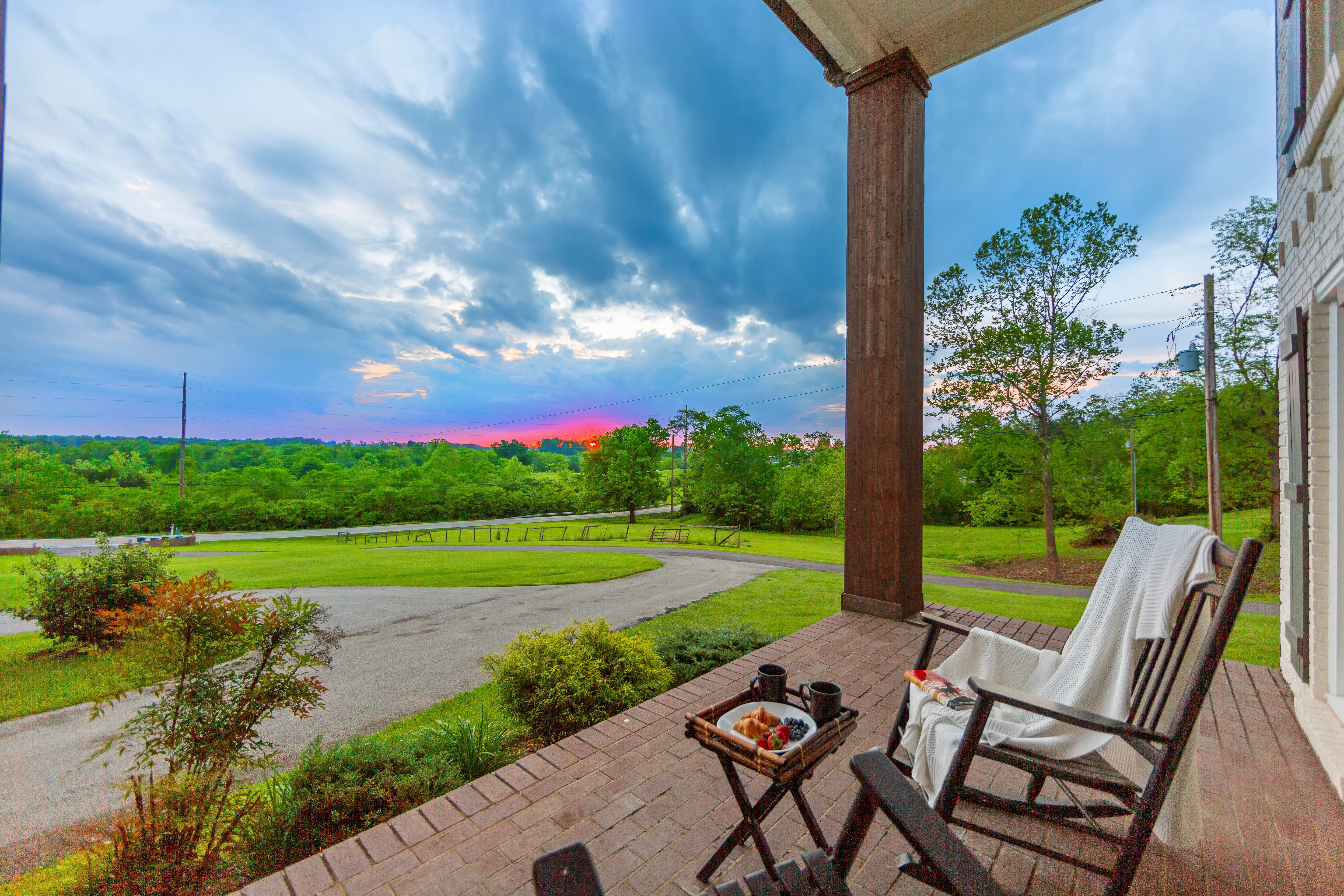 Backyard patio with pergola and seating overlooking manicured grounds at family reunion house La Grange