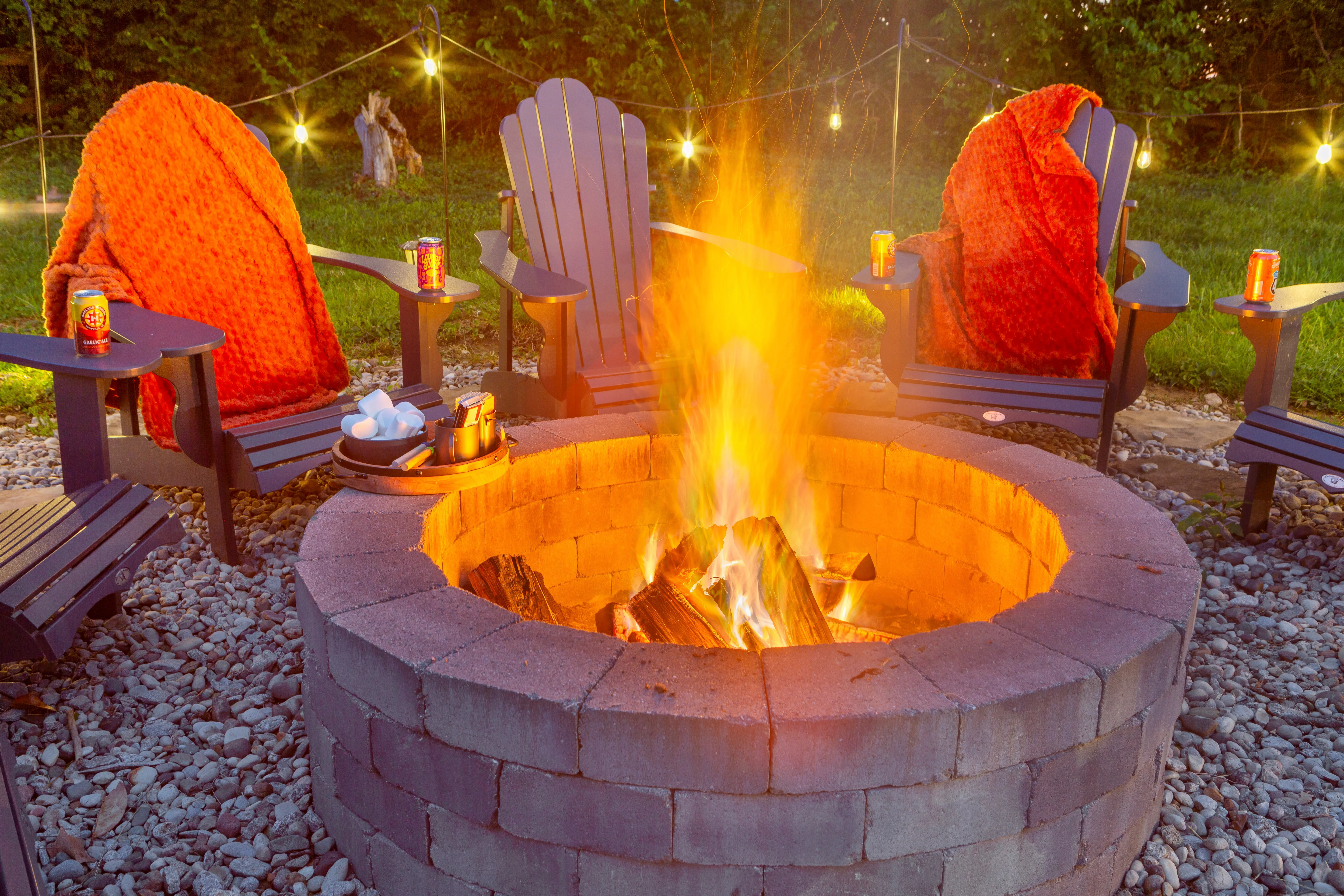 Outdoor fire pit patio with Adirondack chairs, string lights, and cozy ambiance at Glencairn Knoll Louisville