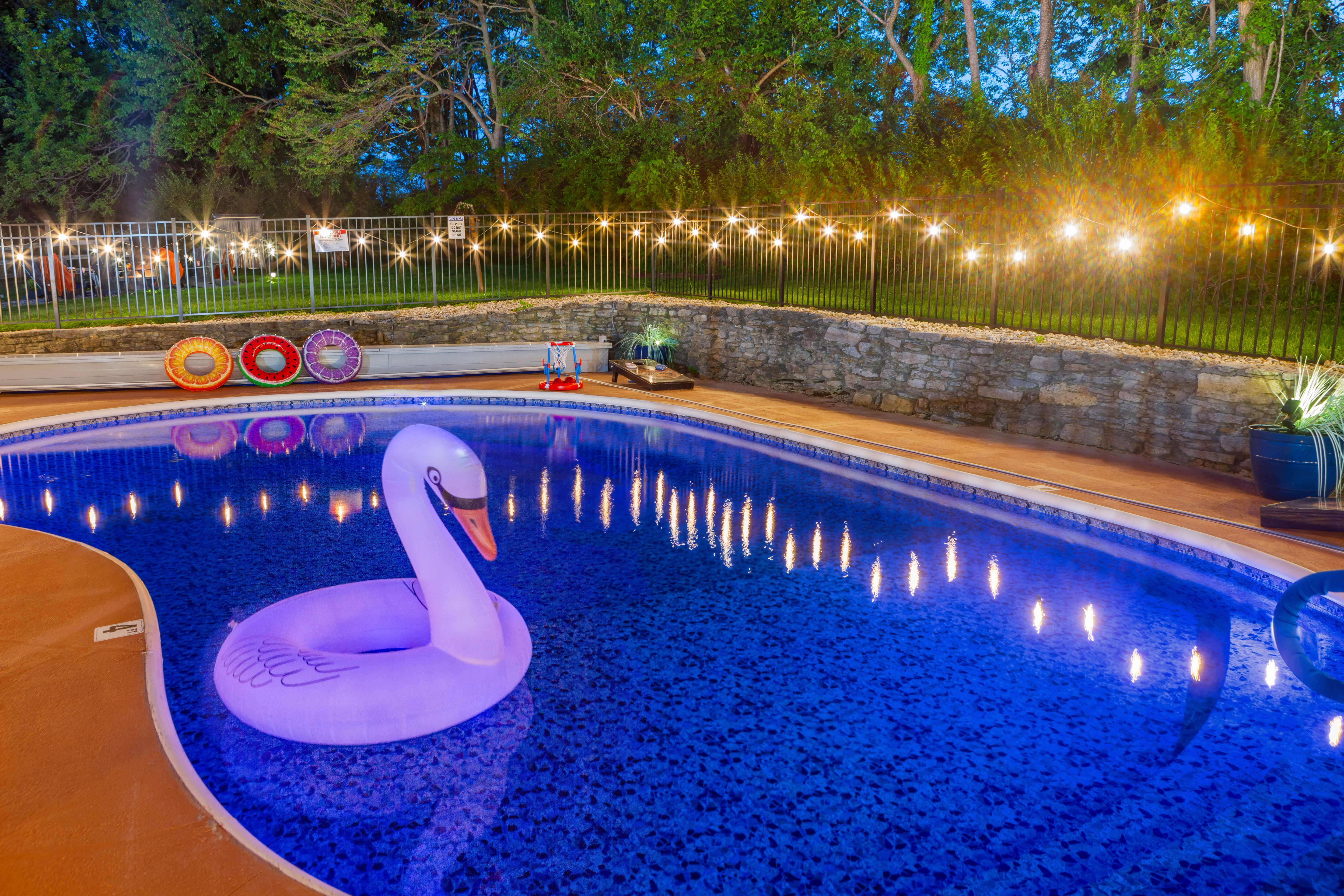 Illuminated pool for unwinding after Louisville nightlife, twilight backyard oasis near Louisville